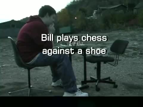 Bill sitting across a chessboard from a shoe